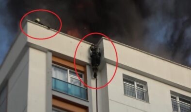 Alevler arasında kalan itfaiye eri kendini itfaiye hortumuyla aşağı bıraktı