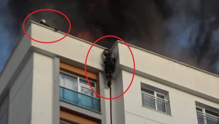 Alevler arasında kalan itfaiye eri kendini itfaiye hortumuyla aşağı bıraktı